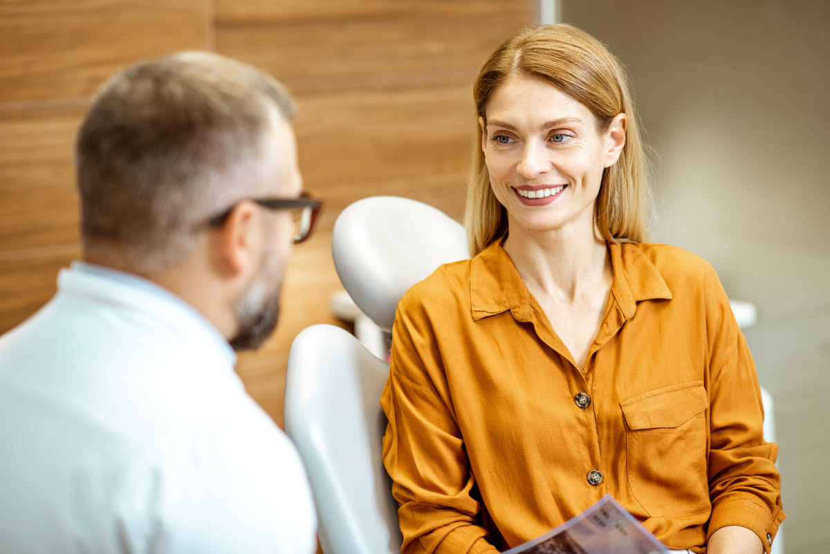 Beautiful adult woman as a patient with senior dentist during a medical consultation at the dental office